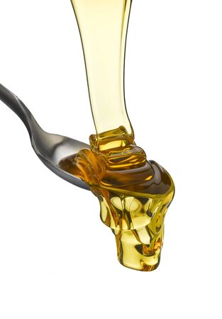 Treacle flowing onto a spoonの写真素材