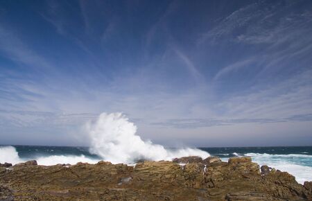 Waves crashing on the rocks at St Francis Bay, South Africaの写真素材