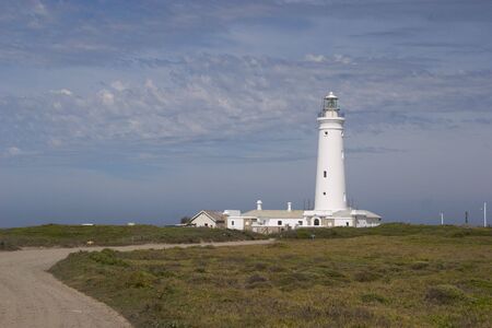 The lighthouse at St Francis Bay, South Africa against a cloudy skyの写真素材