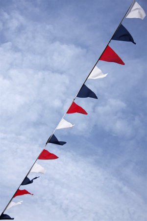 Red white and blue bunting flags in summer skyの写真素材