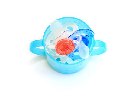 Dummies in a blue beaker. Red, white and blue colours. The small bubbles are the result of the...