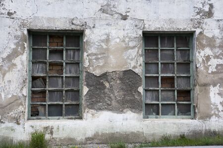 old derelict windows with flaky paint and broken windows
