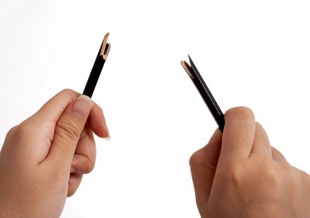 hands trying to break a pencil over a white background