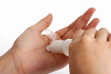 photo of hands putting lotion over a white backgroundの写真素材