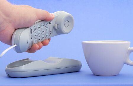 Photo of a telephone over a blue backgroundの写真素材