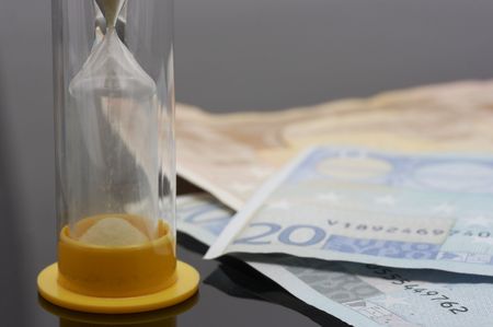 hourglass and euro over a white background