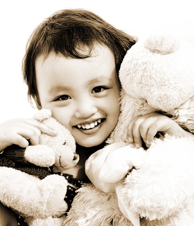 Cute Young Girl Hugging Two Teddy Bears And Smilingの写真素材