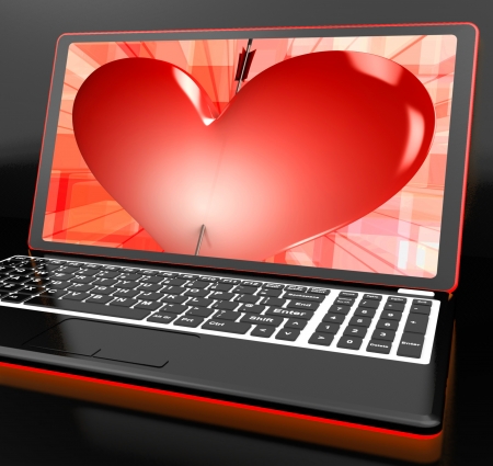 Heart On Laptop Showing Cupid Shot Or Passionの写真素材