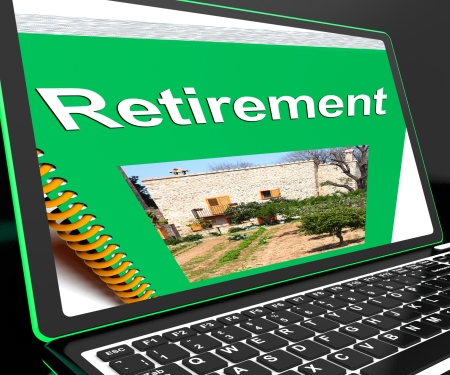 Retirement Book On Laptop Showing Pension Plans And Elderly Advicesの写真素材