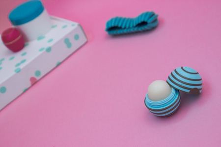 Gift box and Cream for hands in a menthol can of a pink backgroundの写真素材