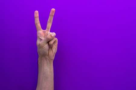 Two counting hands isolated on purple backgroundの写真素材