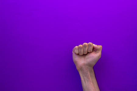 Strong fist up, male hand, sign of strengthの写真素材