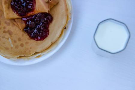 Russian blini pancakes , apple jam and condensed milk. Celebration of Maslenitsa. Maslenitsa is an Eastern Slavic traditional holiday. Orthodox tradition of Russia. Selective focus.の写真素材