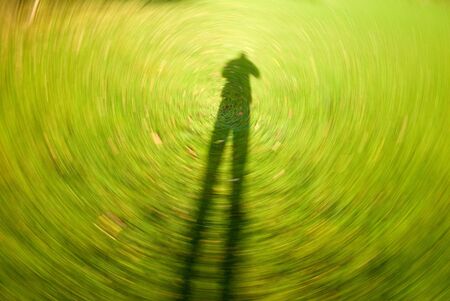 A background depicting a human shadow as the world spins past.の写真素材