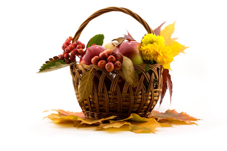 Autumn fruits with yellow leaves in a basket isolated on whiteの写真素材