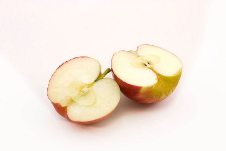 Two half apples sliced on a white backgroundの写真素材