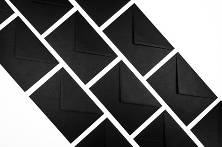 Top view of black envelopes on white background. Post flat lay. Copy space.の写真素材