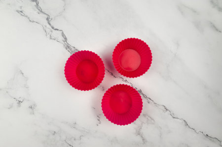 Top view of silicone cupcakes cases on white marble background. Muffins and cupcakes cooking, flat lay, copy space.の写真素材
