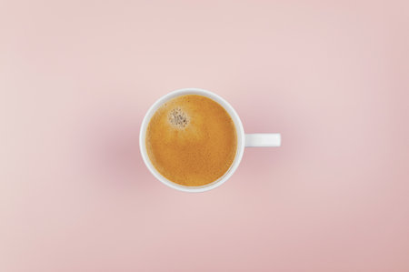 Top view of coffee cup on light pink background. White cup, flat lay, copy space.の写真素材