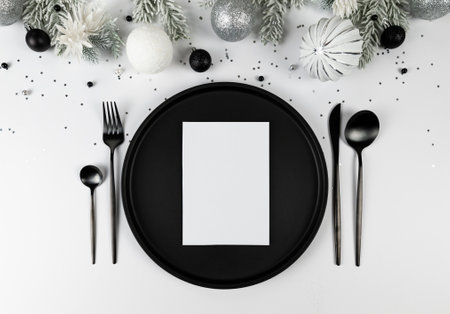 Christmas composition, white and silver decorations, black plate and cutlery, fir tree branches,...