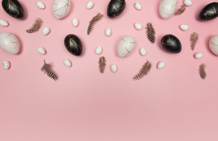 Top view of easter eggs, feathers on pink background. Creative easter composition, spring, flat lay, copy space.の写真素材