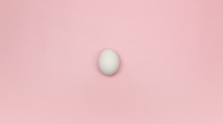 Top view of one white egg on pink background. Creative easter composition, flat lay, copy space....