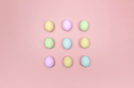 Top view of nine colourful eggs on pink background. Creative easter composition, flat lay, copy space. Spring, modern and minimalist.の写真素材