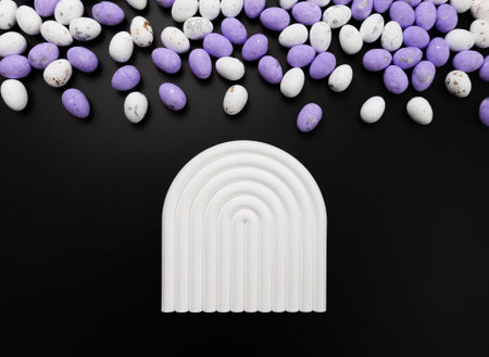Top view of purple and white easter eggs on black background. White arch tray, product presentation....