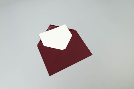Top view of red envelope, white card on grey background. Post flat lay. Copy space.の写真素材