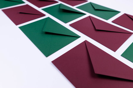 Top view of green and red envelopes on white background. Post flat lay. Copy space.の写真素材