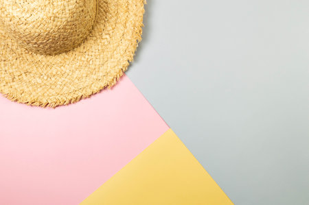 Top view of straw hat on colourful background. Summer fashion, vacation and beach wallpaper. Copy space, flat lay.の写真素材