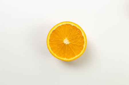Top view of sliced orange on white background. Tropical fruit wallpaper, copy space, flat lay.の写真素材