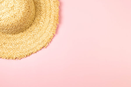 Top view of straw hat on pink background. Summer fashion, vacation and beach wallpaper. Copy space, flat lay.の写真素材