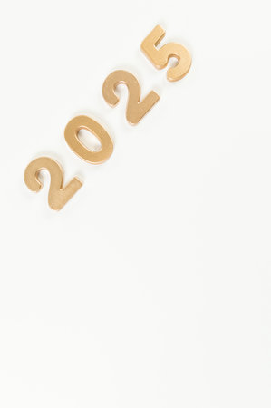 2025 Happy New Year. Top view of gold numbers on white background. Copy space, flat lay.の写真素材