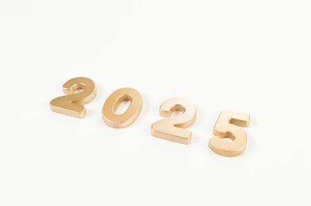 2025 Happy New Year. Top view of gold numbers on white background. Copy space, flat lay.の写真素材