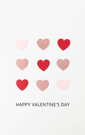 Happy Valentine's Day. Top view of colorful hearts on white background. Pink glitter hearts, red hearts, pink hearts, love wallpaper. Flat lay, copy space.の写真素材