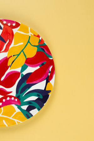 Top view of colorful plate on yellow background. Exotic plant plate, summer picnic. Flat lay, copy space.の写真素材