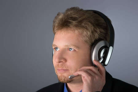 Adult male operator or customer service worker with very attentive sight. Ready to solve any ...