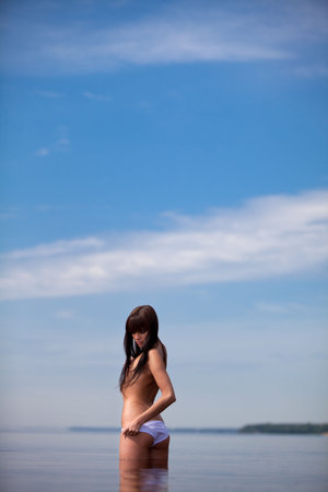 Beautiful brunette in the waterの写真素材