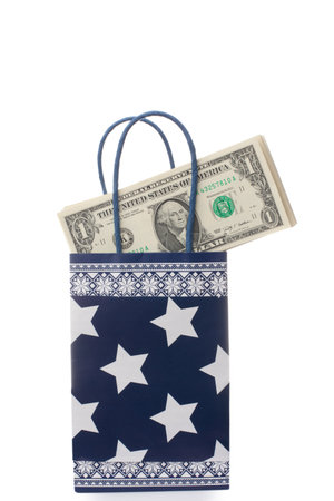 Paper gift bag with heap of money. Isolated over white backgroundの写真素材