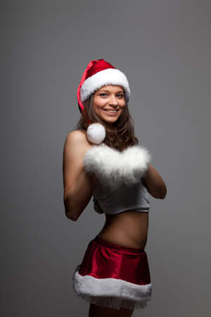 Young positive girl dressed as Santa's helperの写真素材