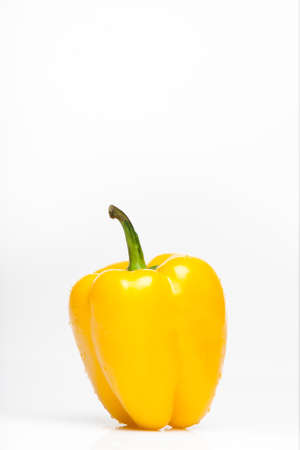 Big fresh yellow pepper with waterdrops on it. Isolated over white background.の写真素材