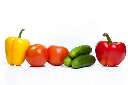 Tomatoes, cucumbers and peppers isolated over white backgroundの写真素材