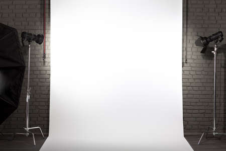 Photo of an empty white background in photographic studio with modern lighting equipment. Empty space for your text or objectsの写真素材