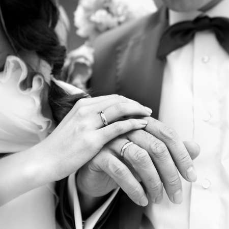Hand of the groom and the bride with wedding rings. Monochrome image.の写真素材
