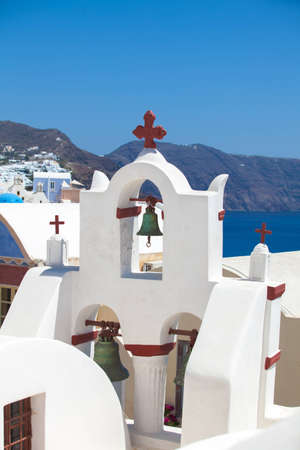 Church bells in Oia village on Santorini island, Greece の写真素材
