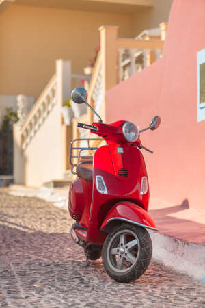 Red italian scooter parked on the street in Oia village, Santorini, Greece の写真素材