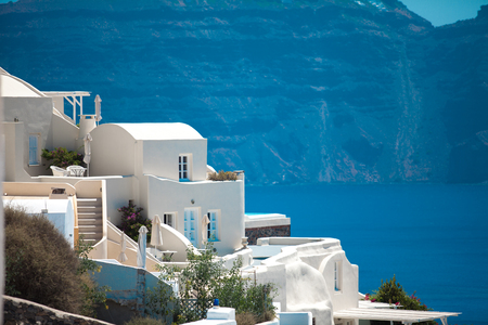 White architecture against mountains background on Santorini island , Greeceの写真素材