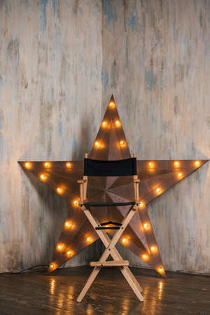 Empty directors chair against a big star