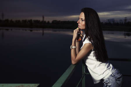 Young beautiful girl outdoors at nightの写真素材